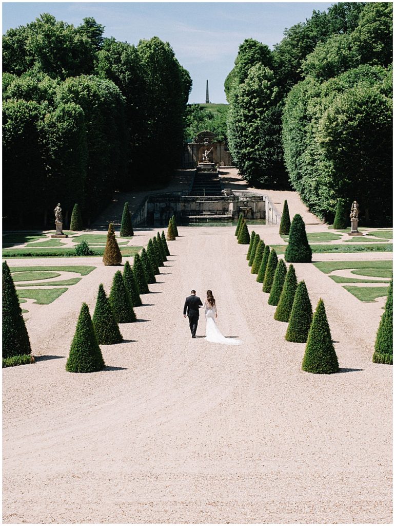 bride and groom in gardens at Chateau de Villette in Paris, France