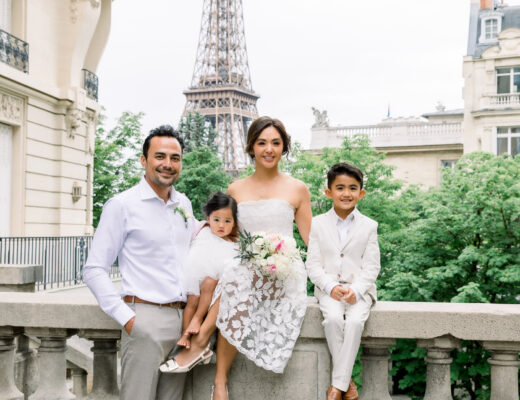 Bride and groom renewing their vows in Paris with their two kids near the Eiffel Tower at sunrise.
